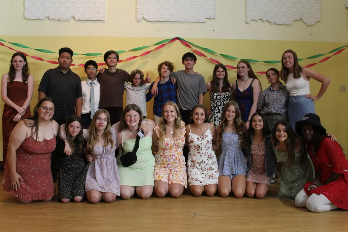 Two rows of students standing together and smiling 