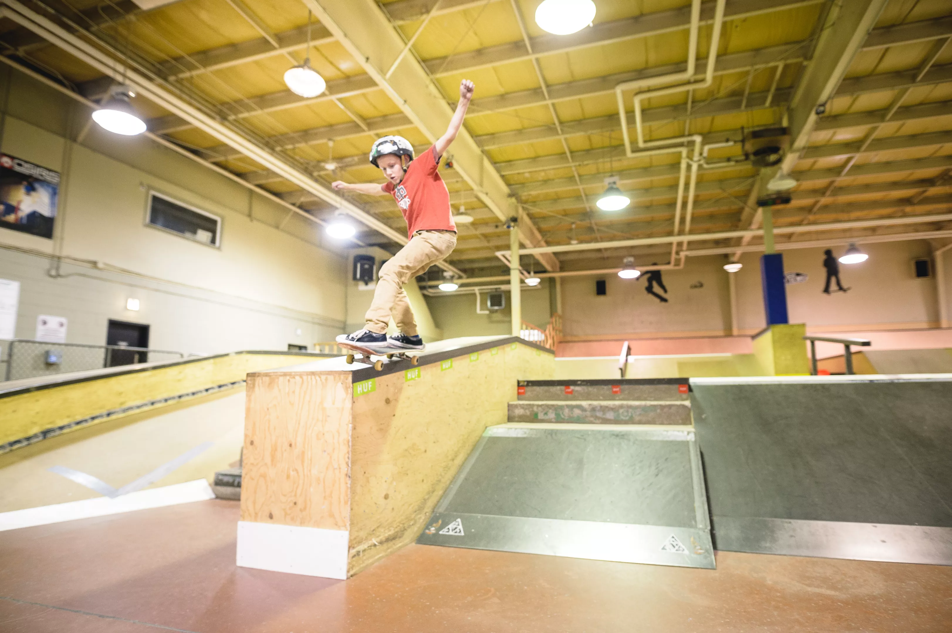 Youth on skateboard at an indoor skatepark