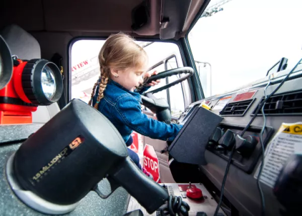 Young girl in driver's seat of Fire Truck
