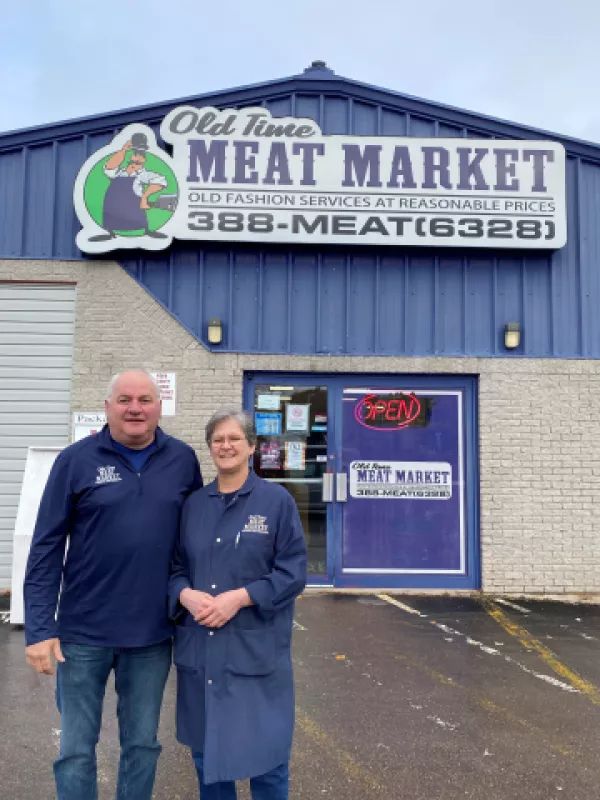 Owners of the Old Fashion Meat Market standing outside business