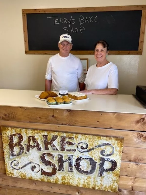 Owners Terry and Francine standing behind their counter inside their bakery