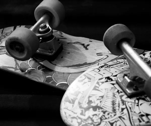 A black and white photo of two skateboards