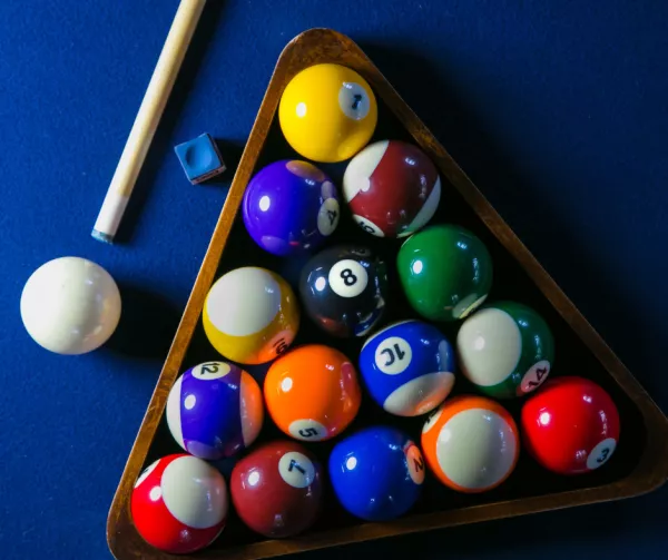 Pool balls on a blue pool table 