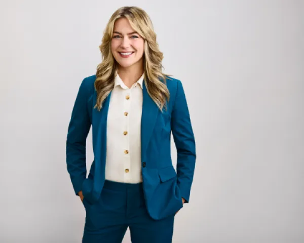 A smiling woman in a blue suit