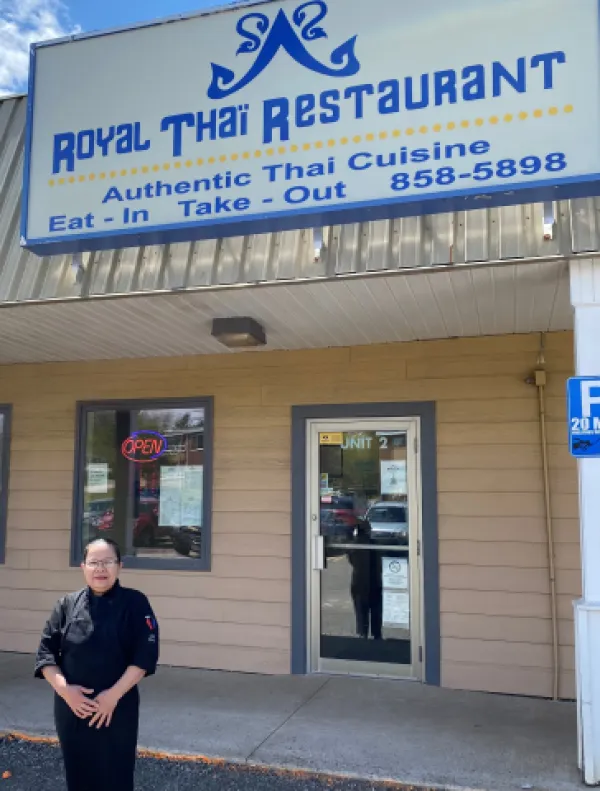 Owner of Royal Thai restaurant standing outside storefront
