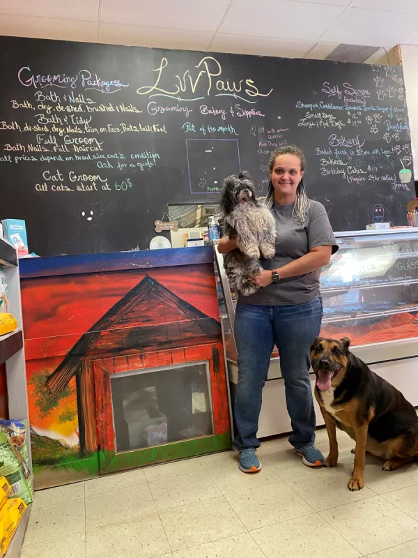 Vickey inside of her shop with her two dogs