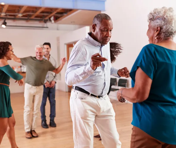 Seniors dancing in a community hall