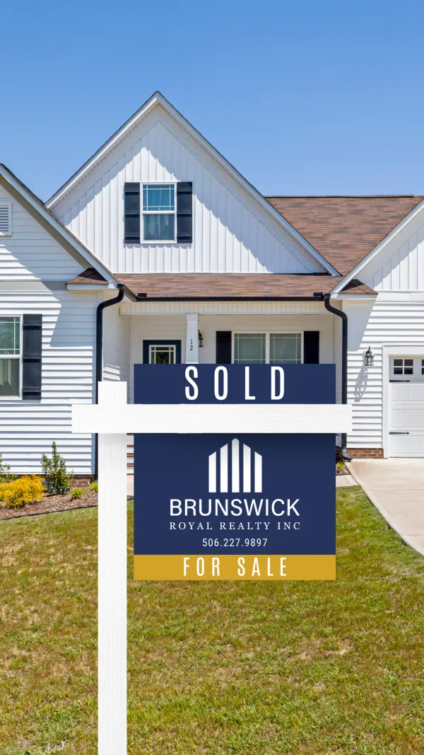 A home with a Brunswick Royal Reality sold sign.