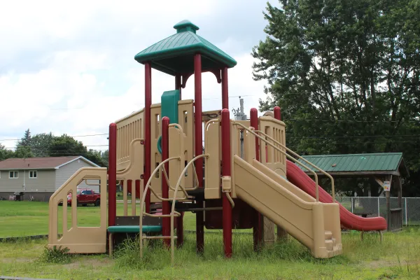 A playground with cloudy blue sky in the background 
