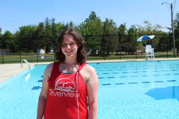 Lifeguard stands beside outdoor pool