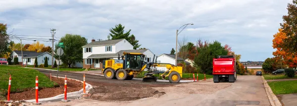 Two trucks working on a residential street