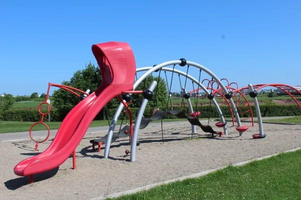 A playground near the river with blue sky 