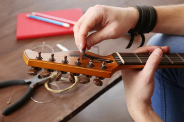 Guitar being held and worked on.