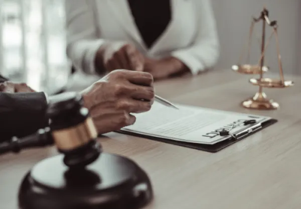 Two people drafting a contract in a law office