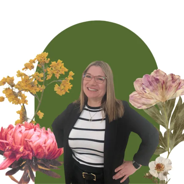 Woman smiling with a green floral backdrop