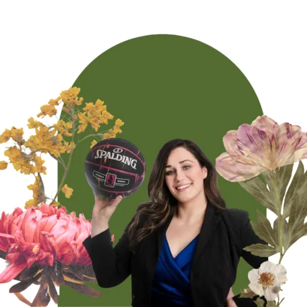 A woman holding a basketball with a floral and green backdrop