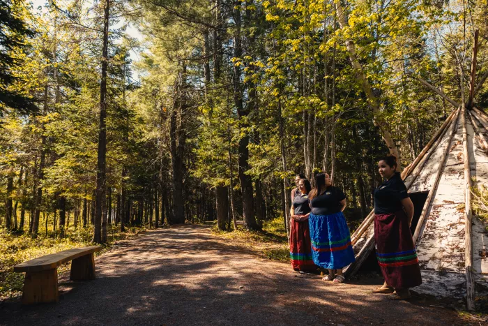 Four Indigenous women standing together in nature