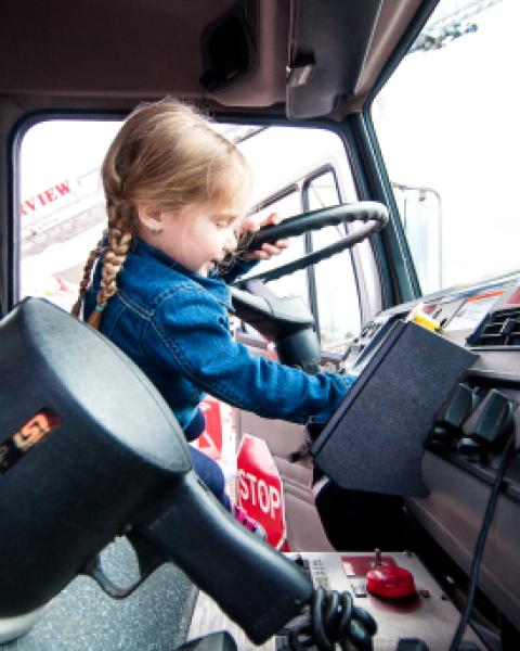 Young girl in driver's seat of Fire Truck