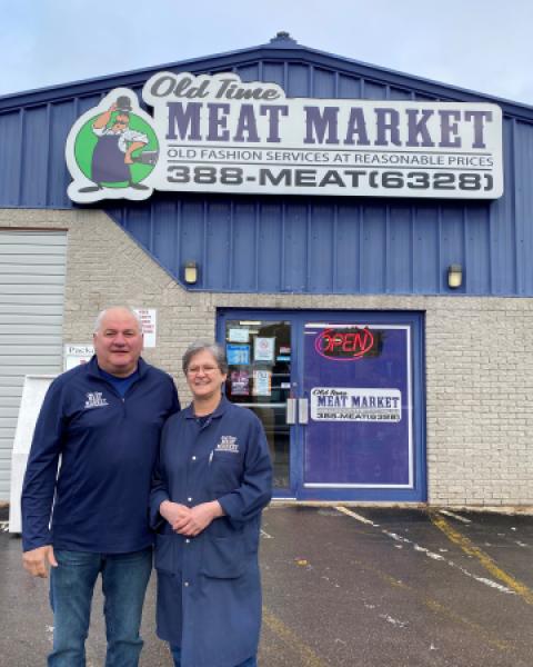 Owners of the Old Fashion Meat Market standing outside business