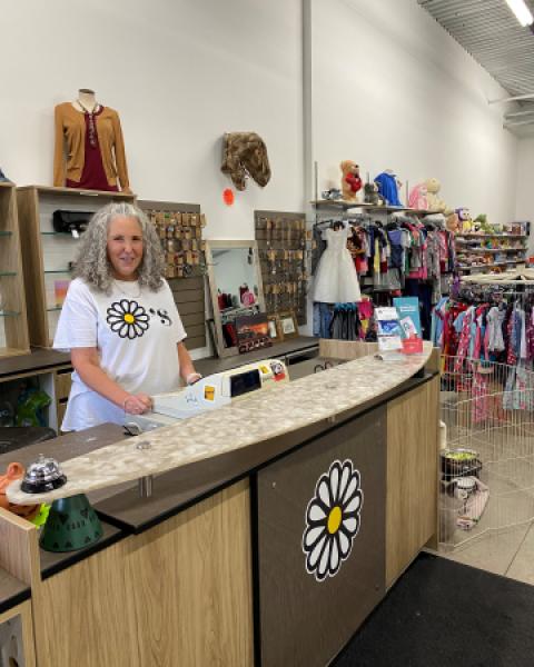 Owner of Dayzee's thrift store standing behind counter