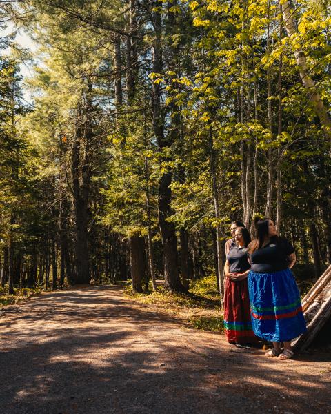 Four Indigenous women standing together in nature