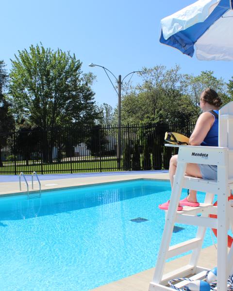 Lifeguard on chair at outdoor pool