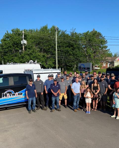 Team from hayward stand beside truck outside their office