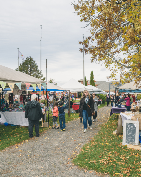 Outdoor market vendors set up on a fall day in the park