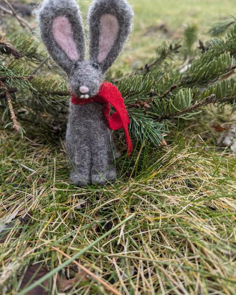 Needle felted winter bunny in the grass.