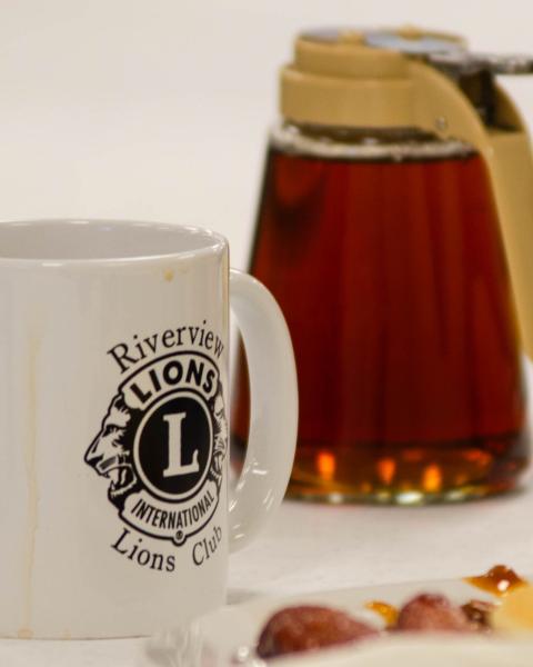 Riverview Lion's Club coffee mug, pitcher of maple syrup